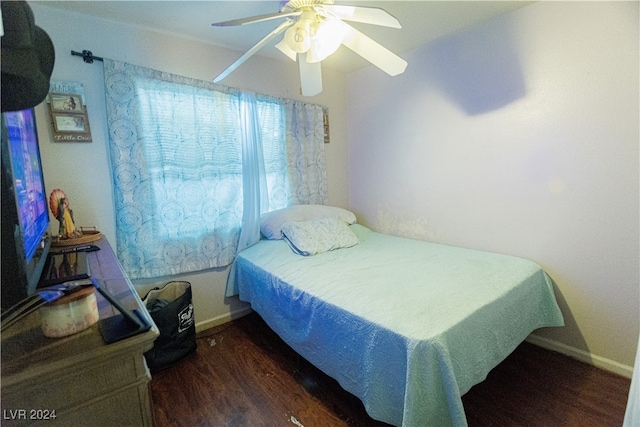 bedroom with ceiling fan and dark hardwood / wood-style floors