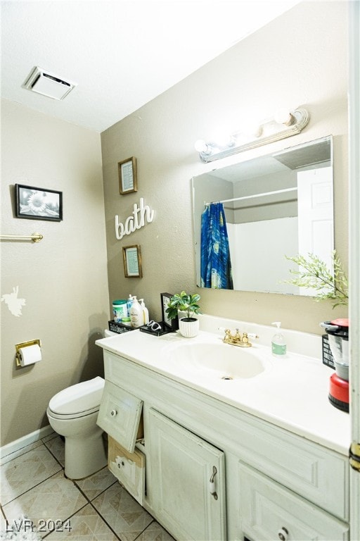 bathroom featuring tile patterned flooring, curtained shower, vanity, and toilet