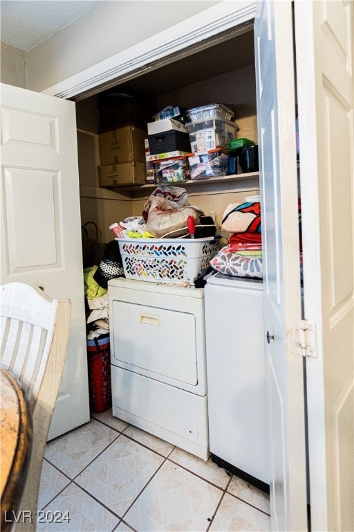 laundry room featuring washer and dryer and light tile patterned floors