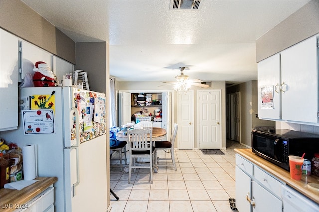 kitchen with ceiling fan, white appliances, and white cabinetry