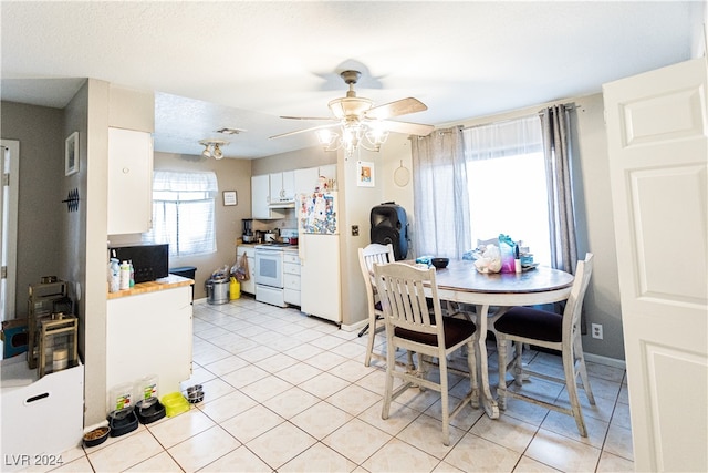 dining room featuring light tile patterned flooring, ceiling fan, and a healthy amount of sunlight