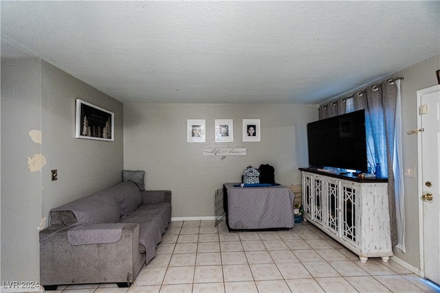 living room featuring light tile patterned floors and a textured ceiling