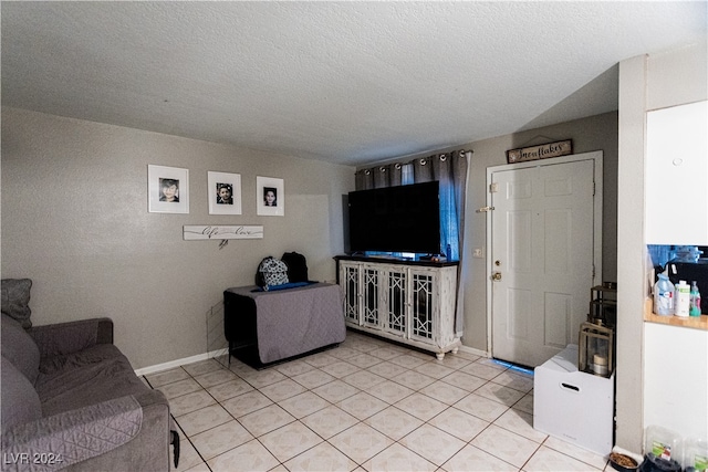 living room with light tile patterned flooring and a textured ceiling