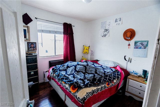 bedroom with dark wood-type flooring