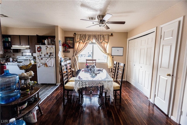 dining area with dark hardwood / wood-style flooring, a textured ceiling, and ceiling fan