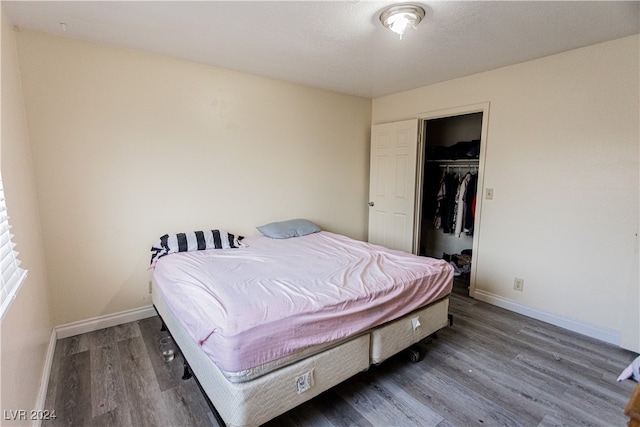 bedroom with a closet and dark hardwood / wood-style flooring