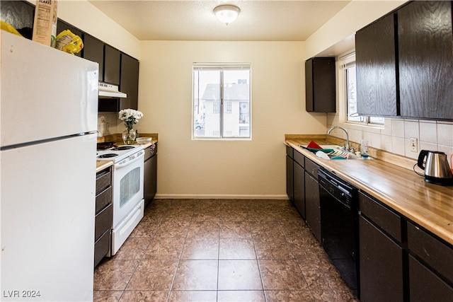 kitchen with tasteful backsplash, white appliances, tile patterned floors, and sink