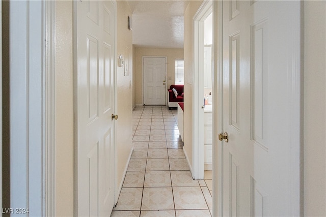 corridor with light tile patterned floors