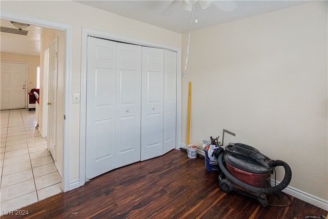 bedroom featuring ceiling fan, a closet, and wood-type flooring