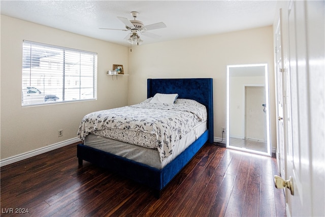 bedroom featuring ceiling fan and dark hardwood / wood-style floors