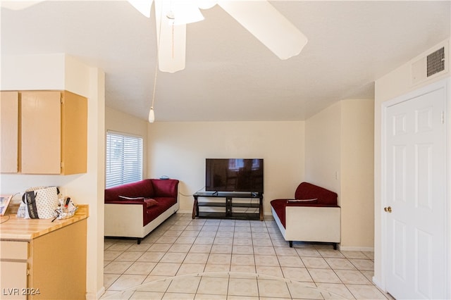 living room with ceiling fan and light tile patterned flooring