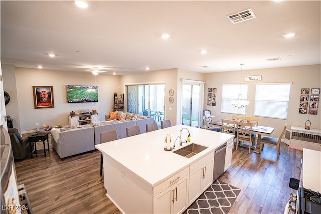 kitchen with white cabinets, sink, stainless steel dishwasher, a center island with sink, and dark hardwood / wood-style flooring