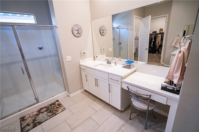 bathroom featuring vanity and a shower with shower door