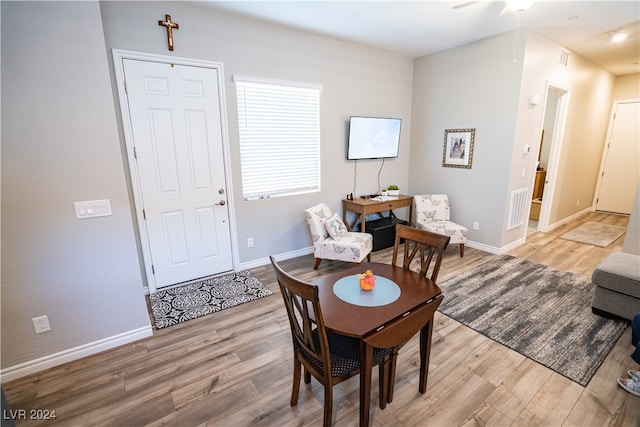 dining room with ceiling fan and light wood-type flooring