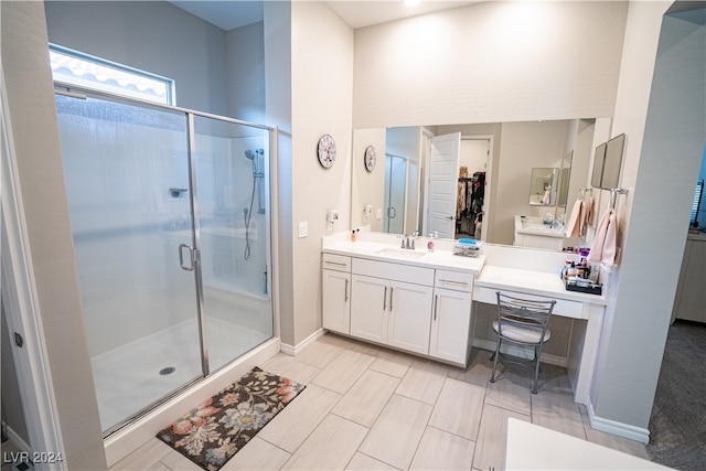 bathroom with vanity and a shower with shower door