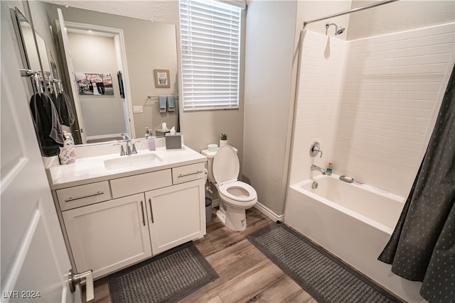 full bathroom featuring shower / tub combo, hardwood / wood-style floors, vanity, and toilet