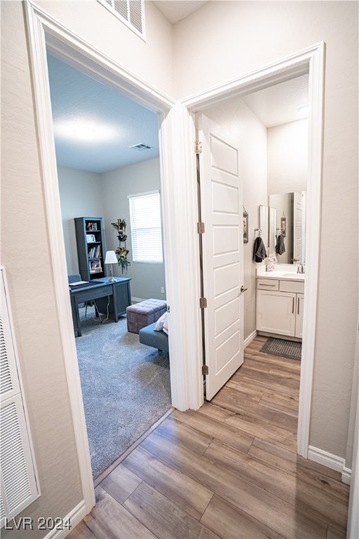 hall with light wood-type flooring