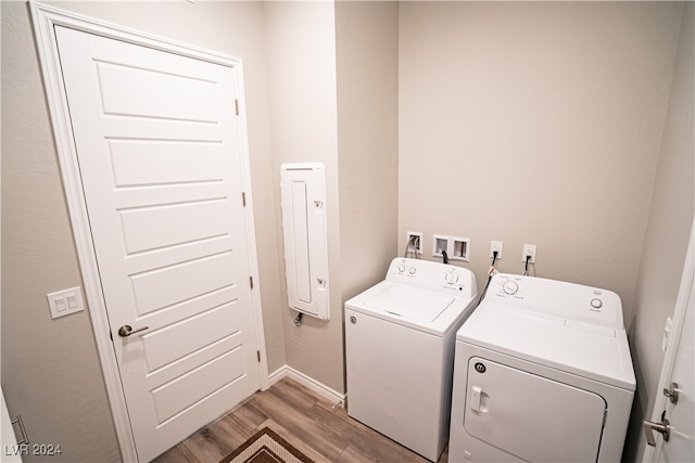 laundry area featuring light wood-type flooring and separate washer and dryer