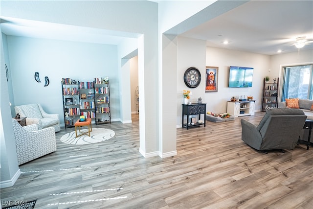 living room featuring ceiling fan and light wood-type flooring