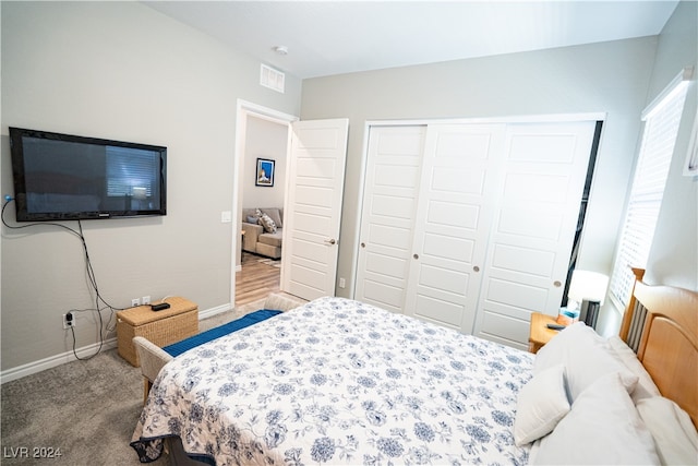 bedroom with light carpet and a closet