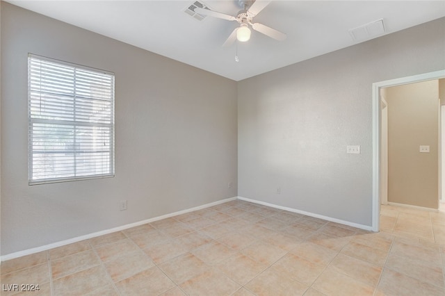 empty room featuring ceiling fan and light tile patterned flooring