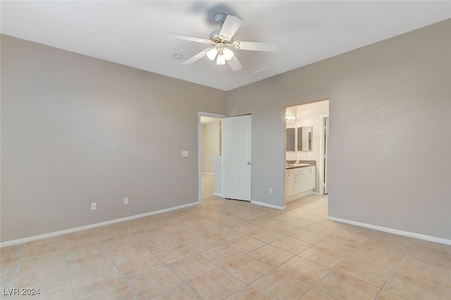 tiled spare room with ceiling fan