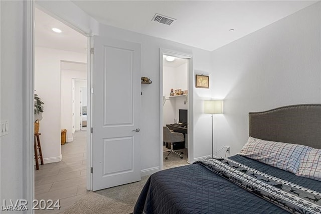 bedroom featuring light carpet