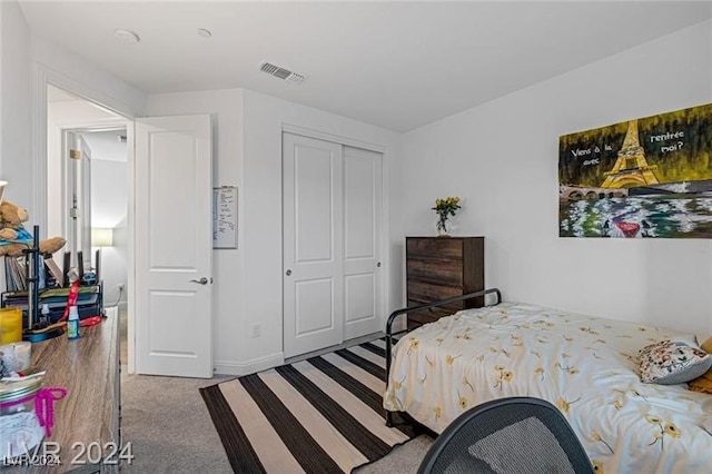 bedroom with carpet and a closet