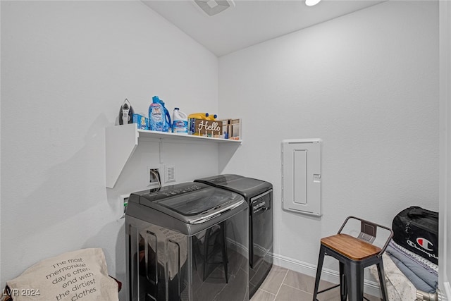 laundry room featuring washer and clothes dryer and light hardwood / wood-style flooring