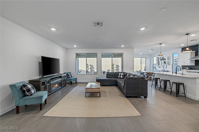 living room featuring light hardwood / wood-style floors, plenty of natural light, and a fireplace