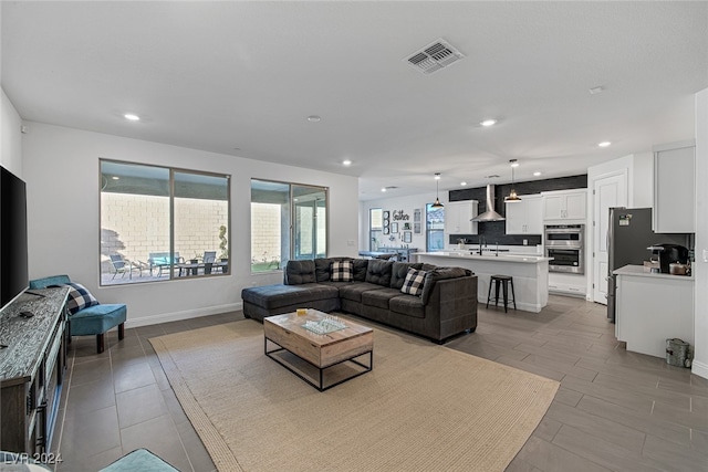 living room featuring sink and plenty of natural light