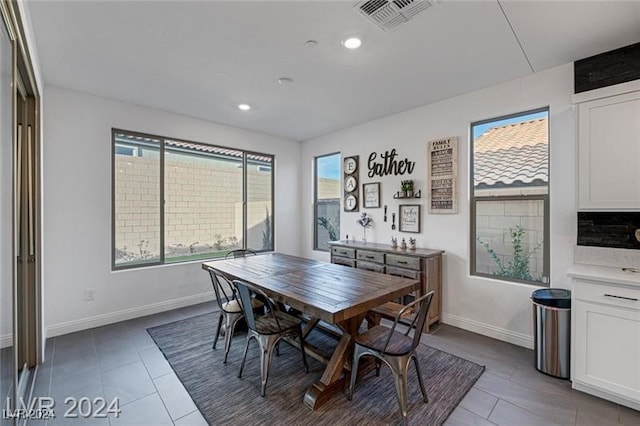 dining space with a wealth of natural light and tile patterned flooring