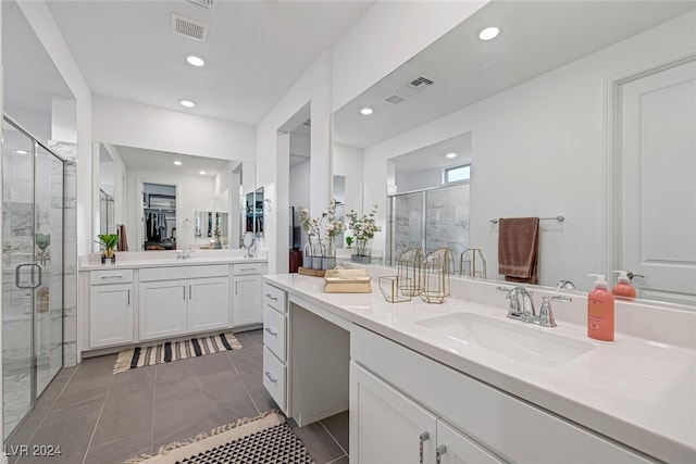 bathroom featuring vanity, an enclosed shower, and tile patterned floors