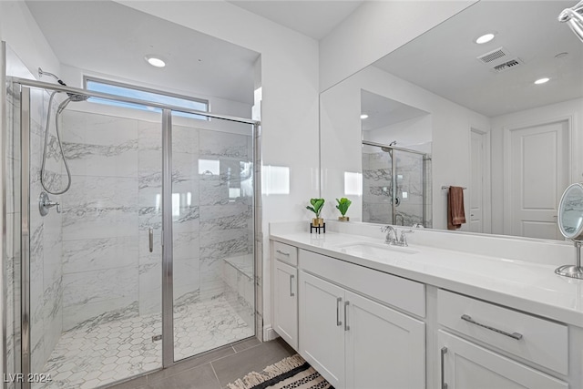 bathroom featuring vanity, tile patterned flooring, and an enclosed shower