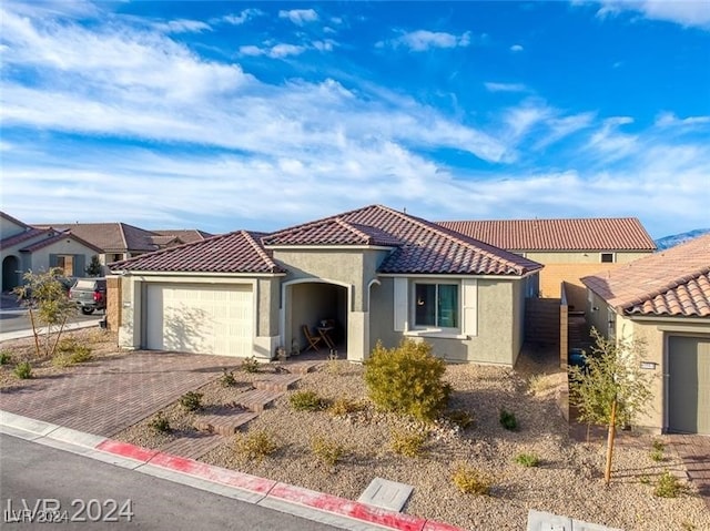 mediterranean / spanish-style home featuring a garage