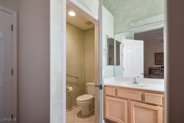 bathroom featuring toilet, vanity, and tile patterned floors