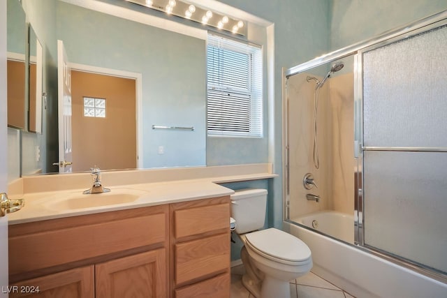 full bathroom with vanity, toilet, combined bath / shower with glass door, and tile patterned flooring