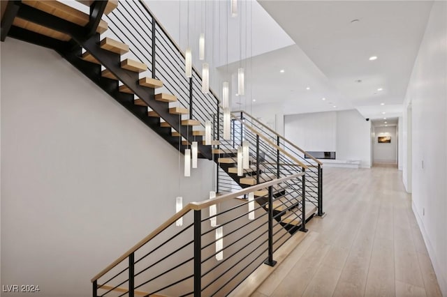 stairway with hardwood / wood-style flooring