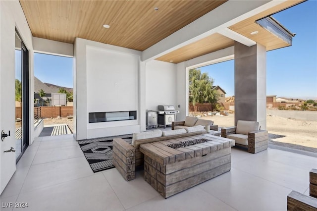 view of patio / terrace with area for grilling and an outdoor fire pit