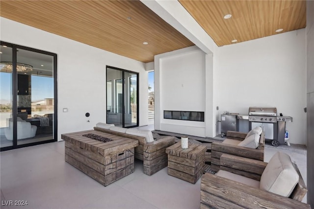 view of patio with grilling area and a fire pit