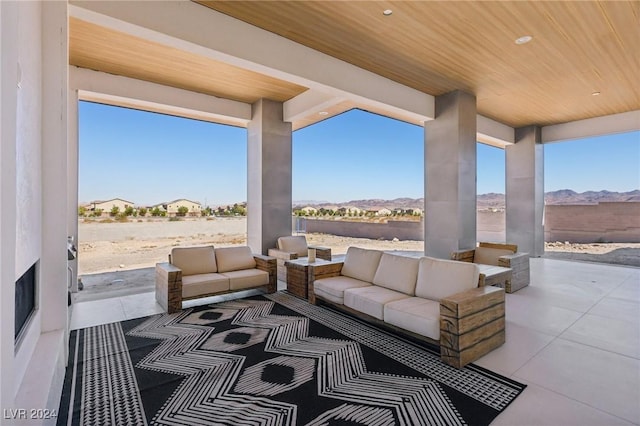 view of patio featuring an outdoor living space and a mountain view