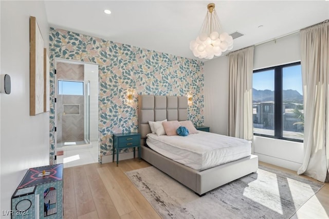 bedroom featuring a mountain view and light wood-type flooring