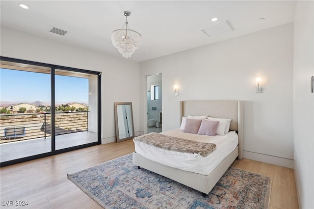 bedroom featuring a notable chandelier, access to outside, and light wood-type flooring