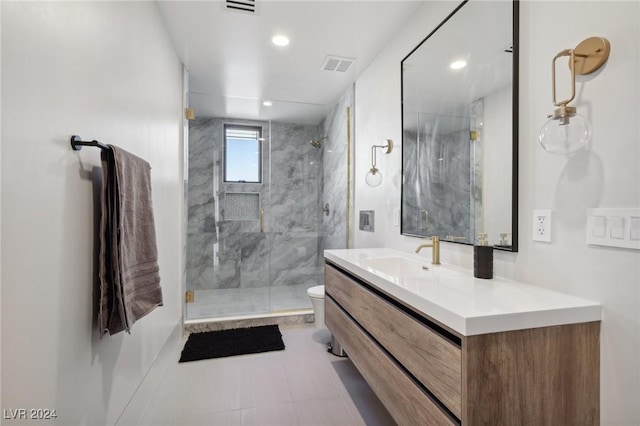 bathroom featuring vanity, toilet, and a shower with door