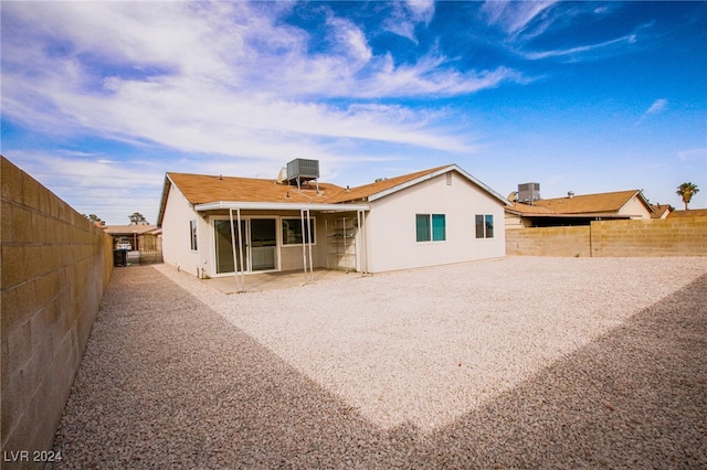 rear view of property featuring a patio area and central air condition unit