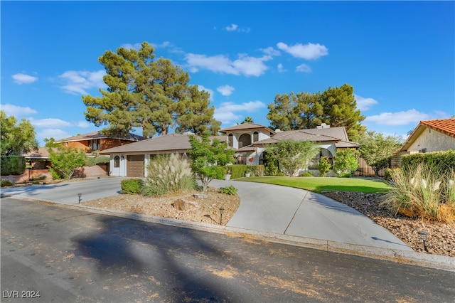 view of front facade featuring a front yard and a garage