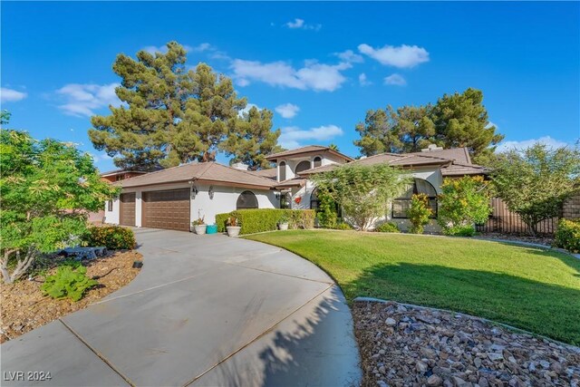 2504 Windjammer Way, Las Vegas, NV 89107 - view of front of property with an attached garage, stucco siding, and driveway