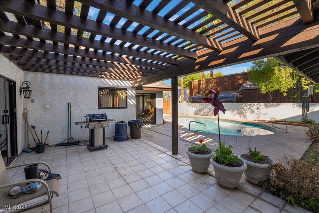 view of patio / terrace featuring a pergola and a fenced in pool