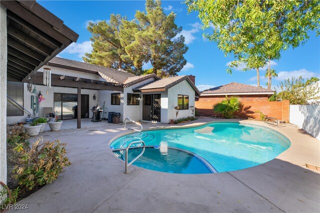 view of pool with a patio area and area for grilling