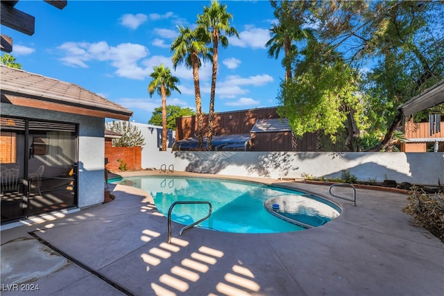 view of swimming pool featuring a patio area